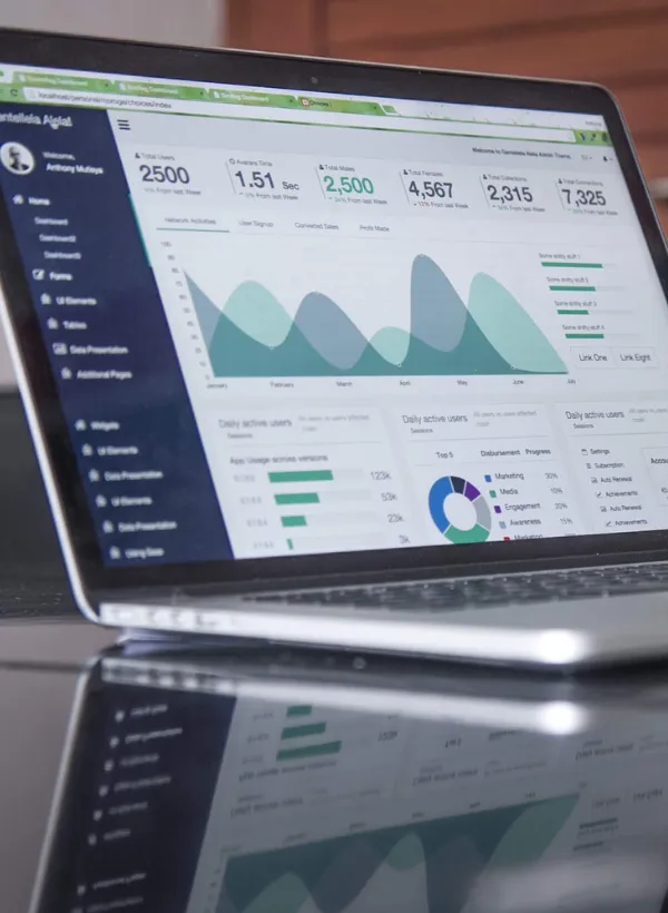 Laptop screen displaying analytics dashboard filled with data